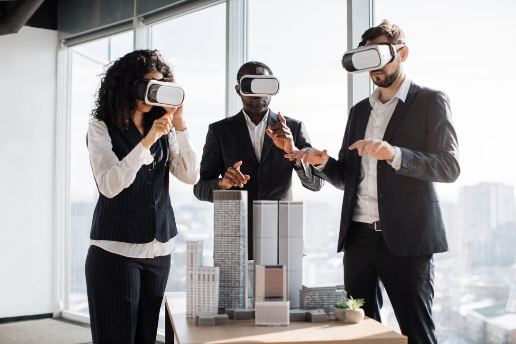 Three corporate people wearing VR headsets