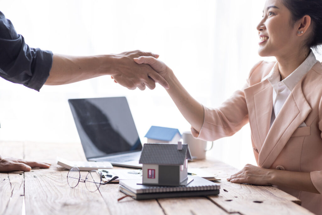 Two people doing a handshake on real estate property deal